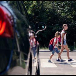 stopped vehicle and students in crosswalk