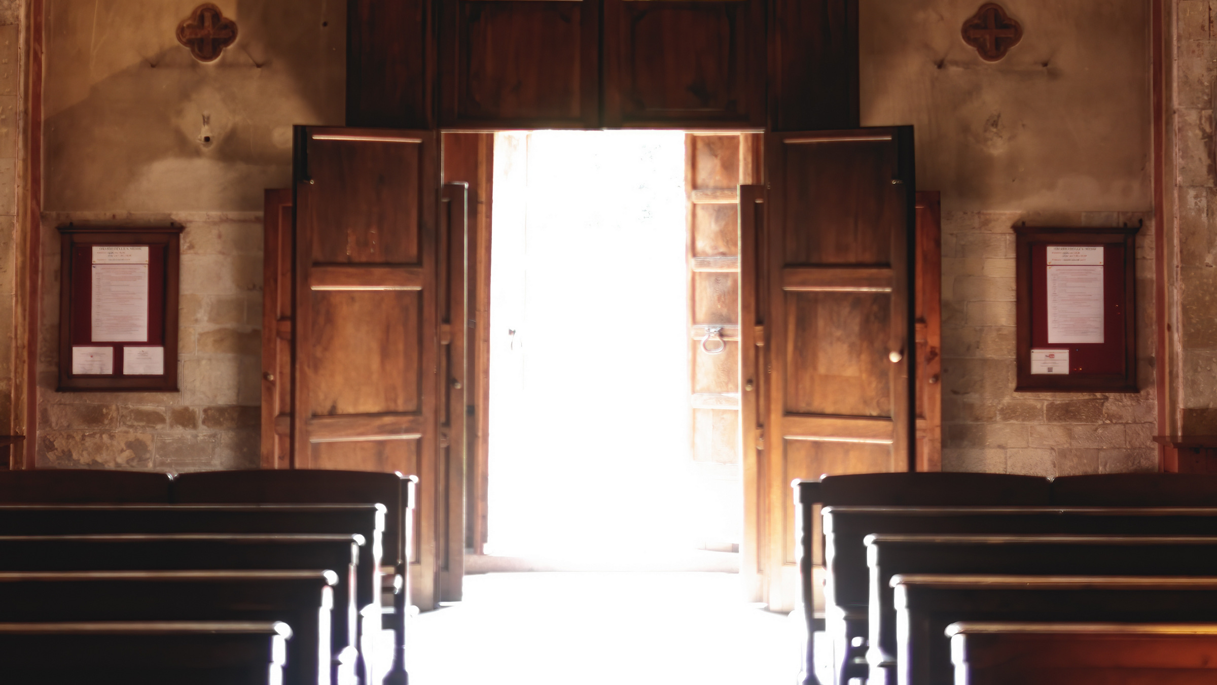 light outside of open church doors, inside view